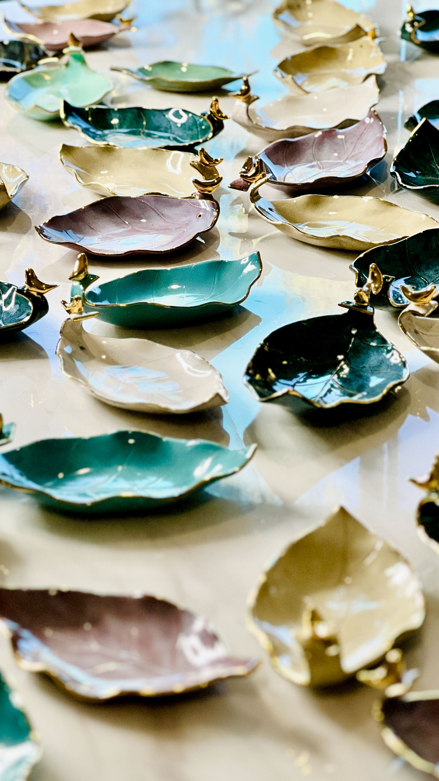 Handmade ceramic leaf-shaped incense holders featuring 24K gold rims and bird accents, crafted in Melbourne, Australia.