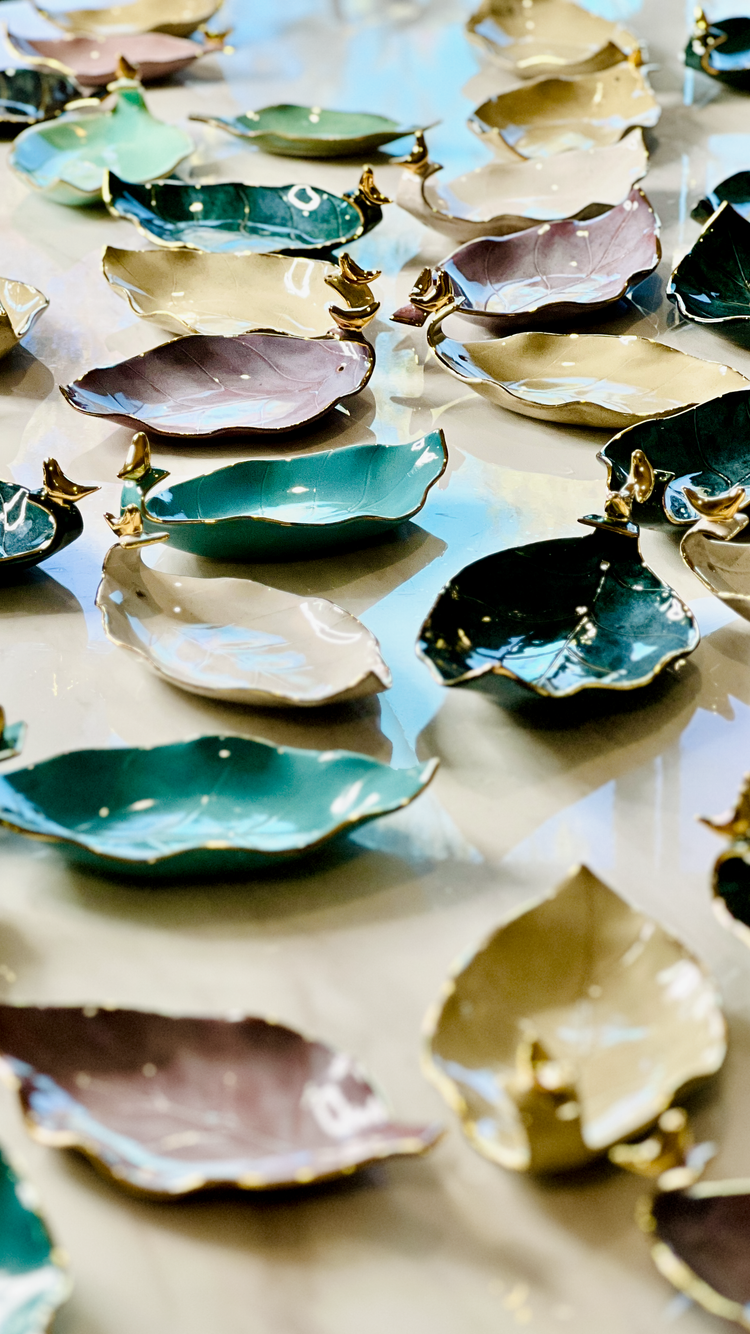 Handmade ceramic leaf-shaped incense holders featuring 24K gold rims and bird accents, crafted in Melbourne, Australia.
